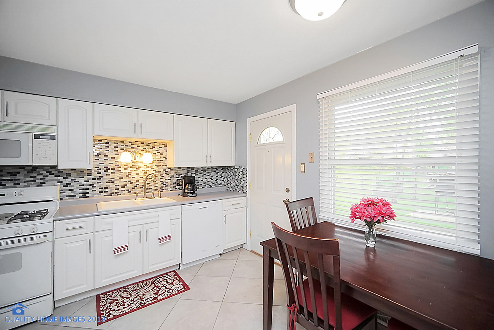 5119 Riverside Drive Richton Park, IL 60471 - Photo 12 of 26 a kitchen with stainless steel appliances cabinets table and chairs