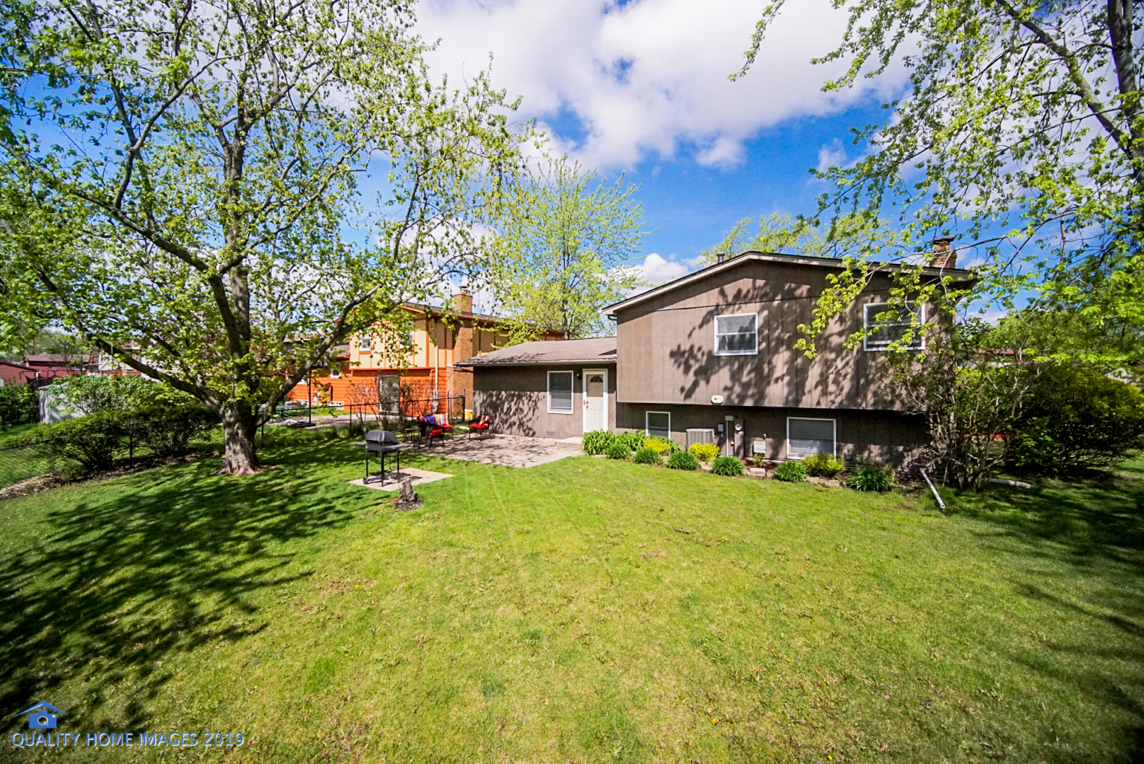 5119 Riverside Drive Richton Park, IL 60471 - Photo 24 of 26 a view of a house with a big yard and large trees