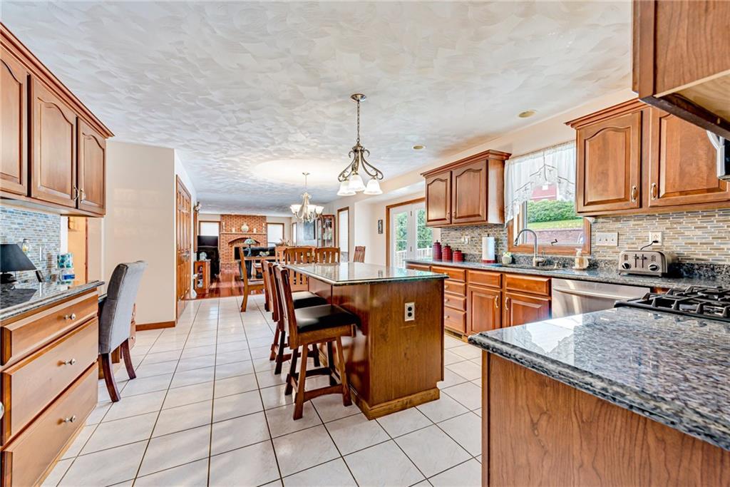 612 Rembrandt Circle Irwin, PA 15642 - Photo 11 of 32 a kitchen with stainless steel appliances granite countertop a sink a stove counter space and cabinets