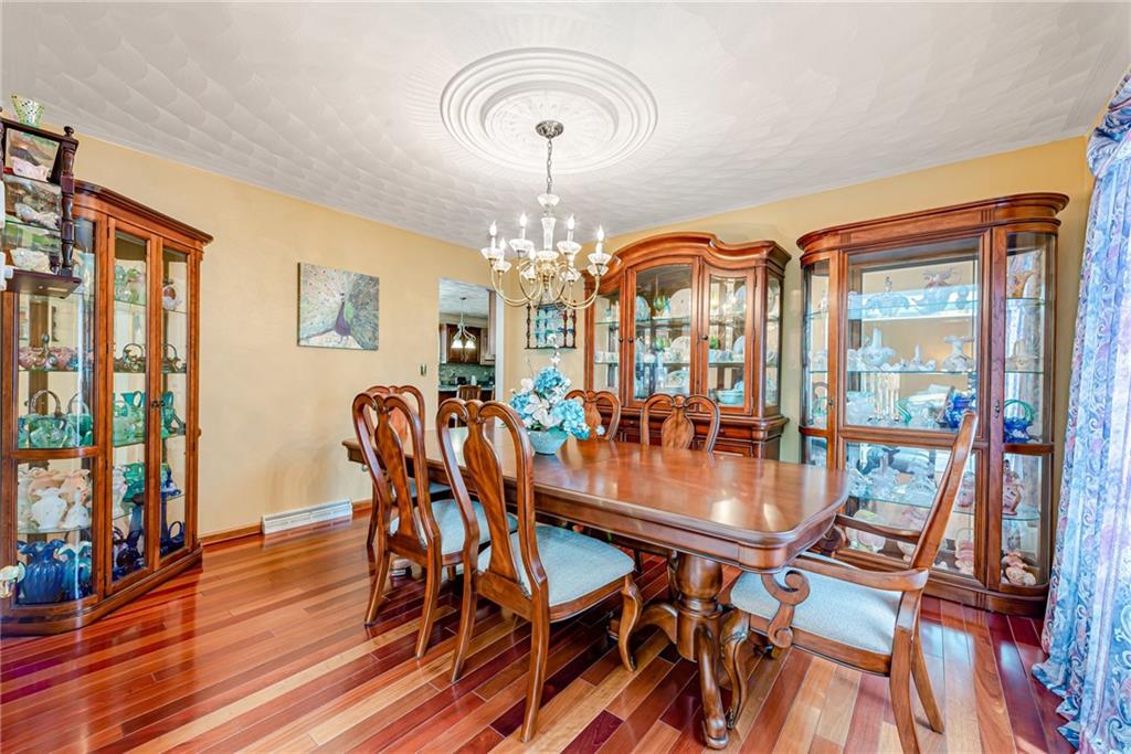 612 Rembrandt Circle Irwin, PA 15642 - Photo 14 of 32 a dining room with furniture a chandelier and wooden floor