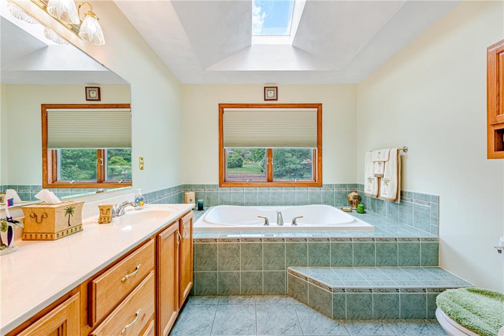 612 Rembrandt Circle Irwin, PA 15642 - Photo 19 of 32 a bathroom with a tub sink and mirror