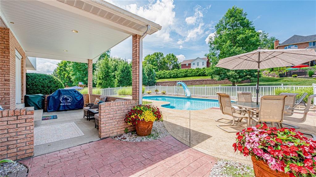 612 Rembrandt Circle Irwin, PA 15642 - Photo 31 of 32 a view of a patio with a table chairs and a floor to ceiling window