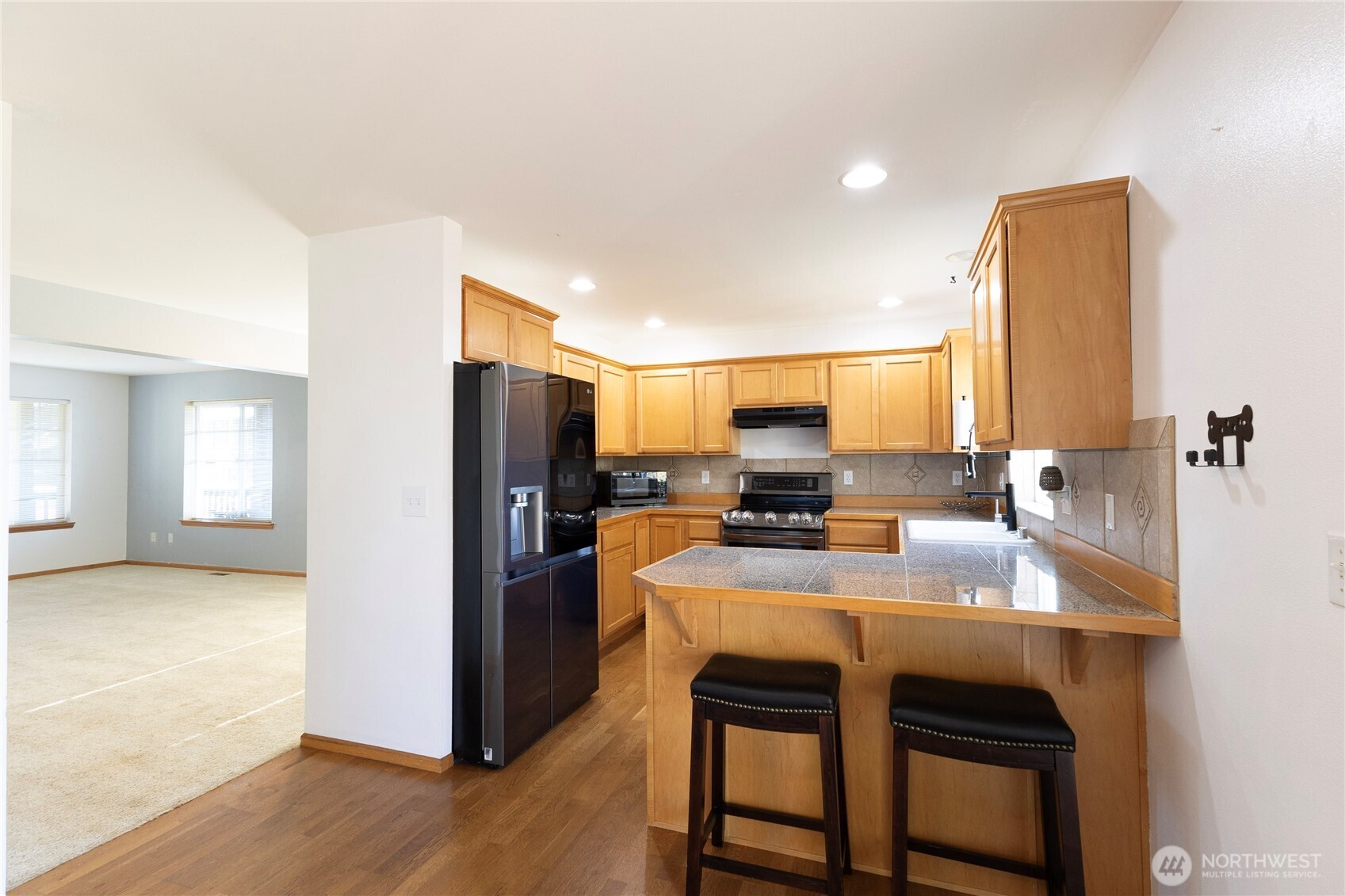 1877 Emerald Way Lynden, WA 98264 - Photo 13 of 33 a kitchen with refrigerator a sink and a stove