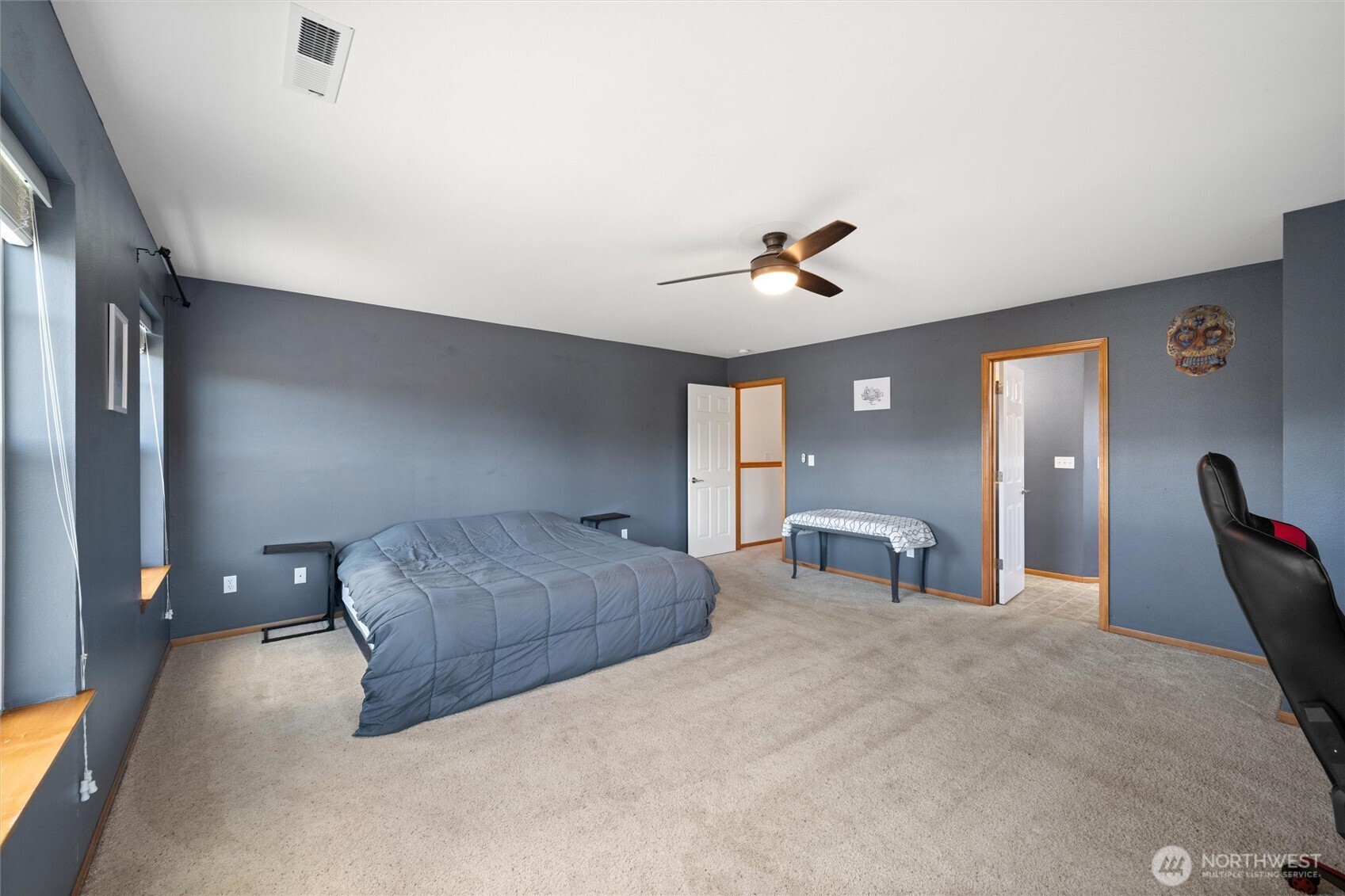 1877 Emerald Way Lynden, WA 98264 - Photo 18 of 33 a bedroom with a bed and a chandelier