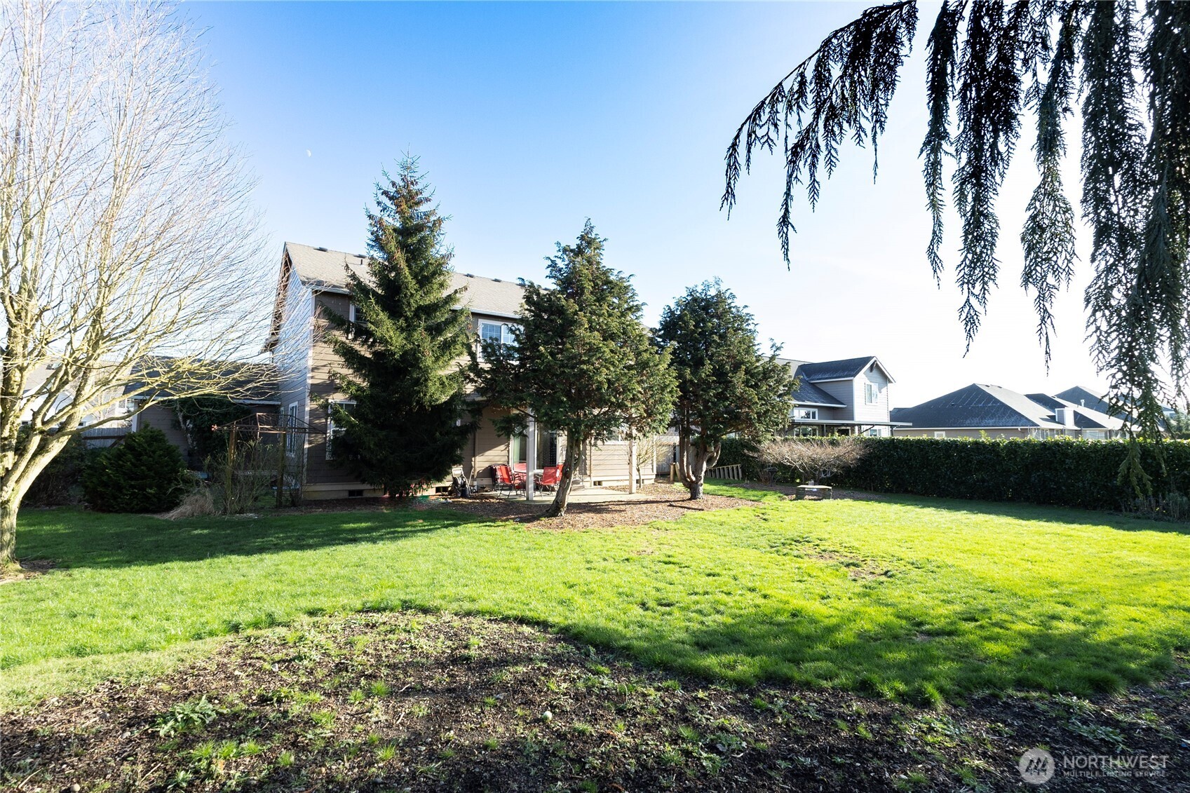 1877 Emerald Way Lynden, WA 98264 - Photo 31 of 33 a view of swimming pool with a garden and trees