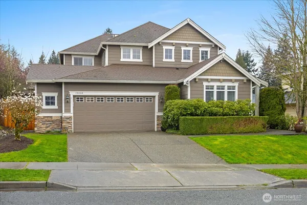 a front view of a house with a yard and garage