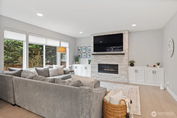 a living room with furniture a flat screen tv and a fireplace