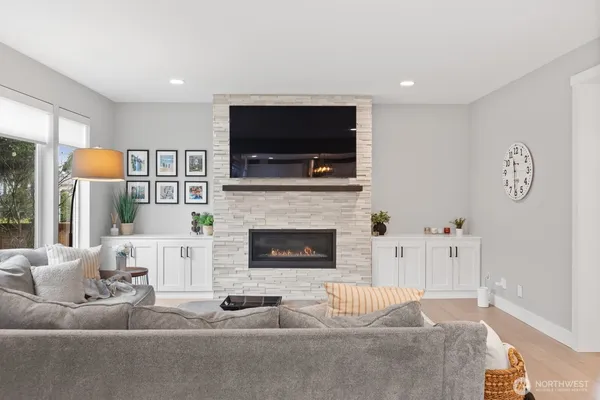 a living room with furniture a flat screen tv and a fireplace