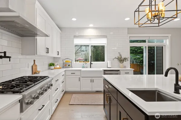 a kitchen that has a sink and a stove