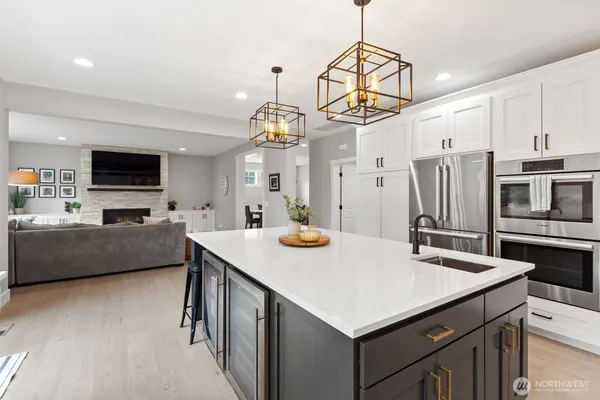 a kitchen that has a lot of cabinets a sink and a stove
