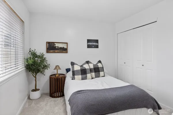 a bedroom with furniture and a potted plant