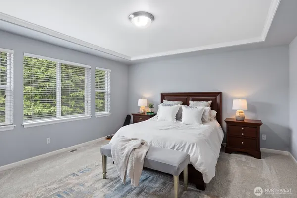 a bedroom with a bed and a large window