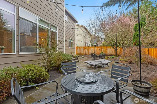 a view of a patio with couches table and chairs and potted plants