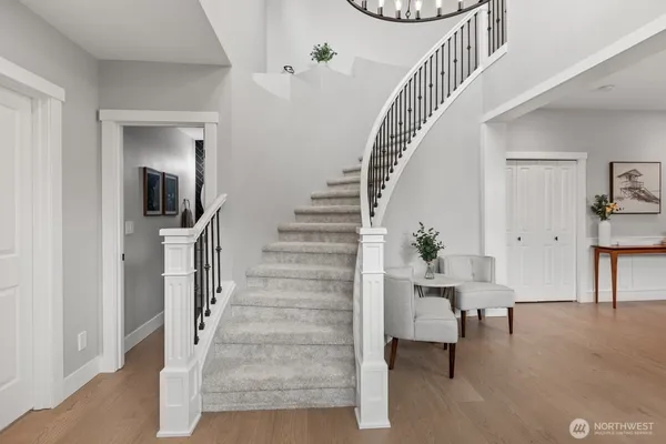 a view of entryway and hall with wooden floor