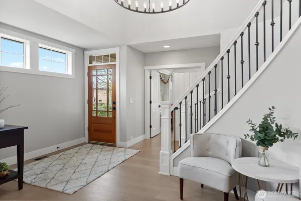 a view of an entryway with wooden floor and a livingroom