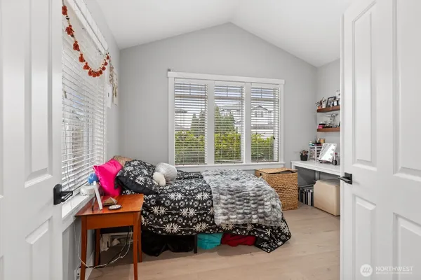 a bed room with a bed and a window
