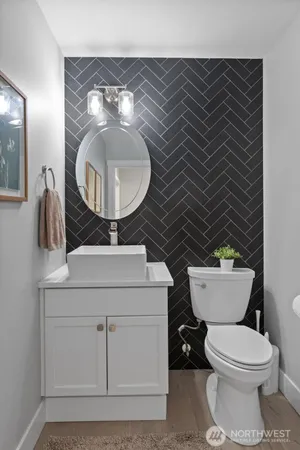 a bathroom with a toilet and a mirror