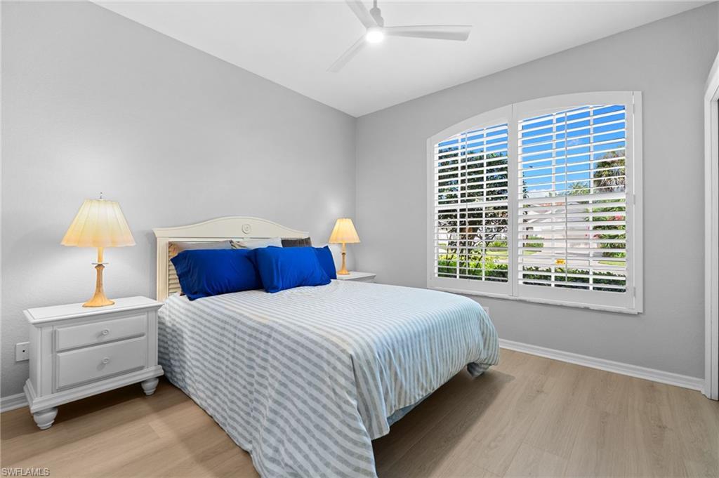 1717 Winding Oaks Way Naples, FL 34109 - Photo 19 of 29 a bedroom with bed and a window