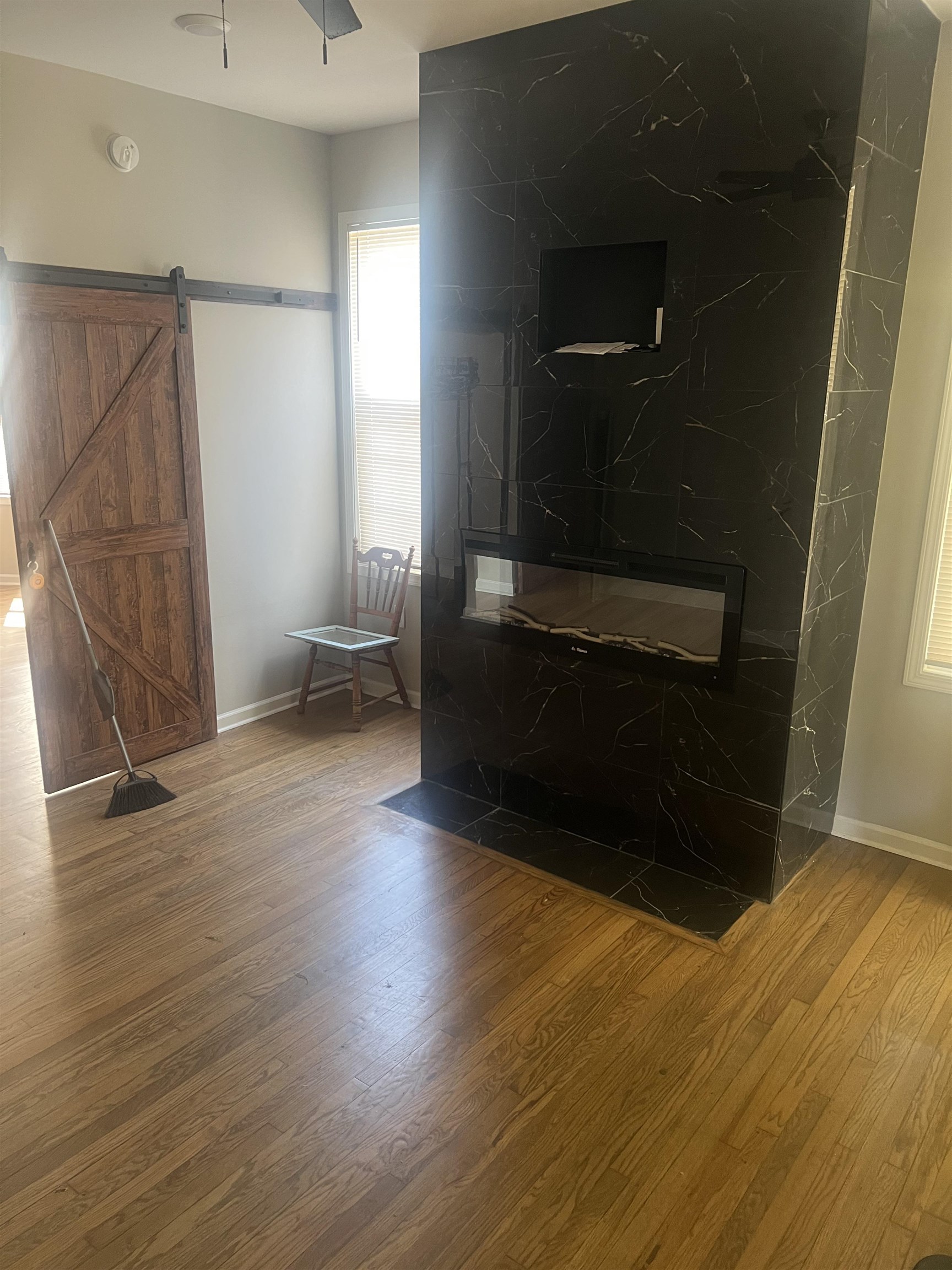 1353 Harbert Avenue Memphis, TN 38104 - Photo 4 of 18 a view of an empty room with wooden floor and a window