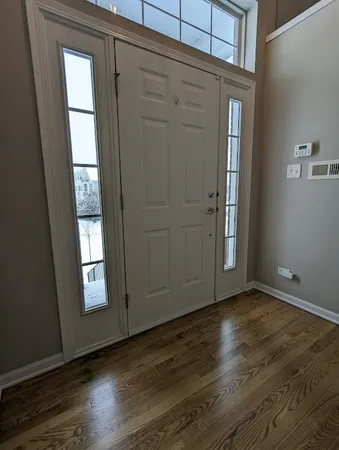 an empty room with wooden floor and closet