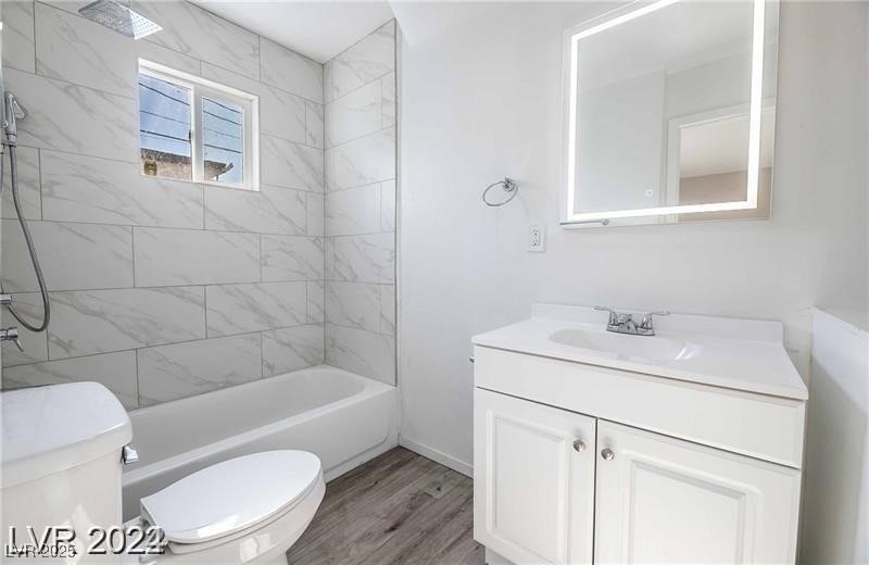 2201 Fairfield Avenue, Unit 13 Las Vegas, NV 89102 - Photo 3 of 5 Full bathroom with vanity, wood finished floors, and shower combination