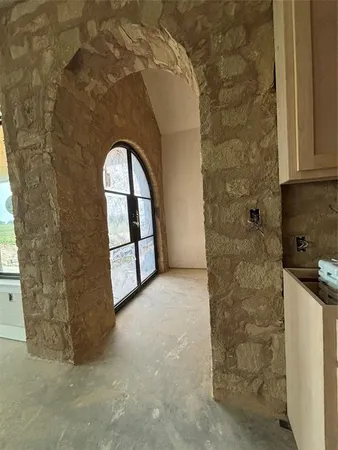 a view of large kitchen with refrigerator and windows