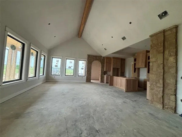 a view of an empty room with large windows