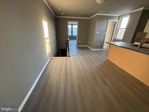 a view of a hallway with wooden floor and stairs