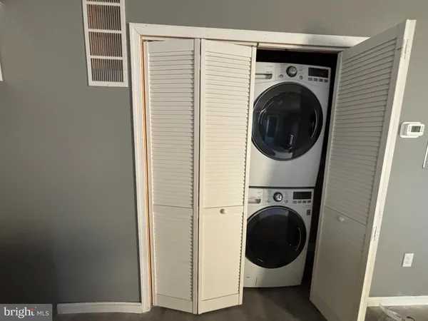 a view of a hallway with washer and dryer