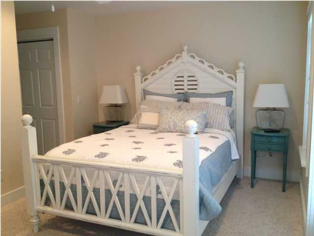 249 Beach Bike Way Seacrest, FL 32461 - Photo 15 of 24 a bed sitting in a bedroom next to a bathroom sink