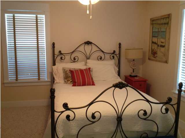 249 Beach Bike Way Seacrest, FL 32461 - Photo 20 of 24 a bedroom with a bed and a chandelier