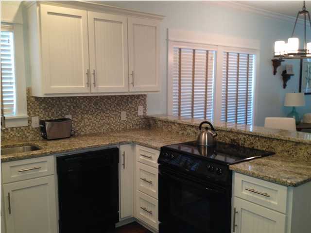 249 Beach Bike Way Seacrest, FL 32461 - Photo 4 of 24 a kitchen with granite countertop cabinets sink and window
