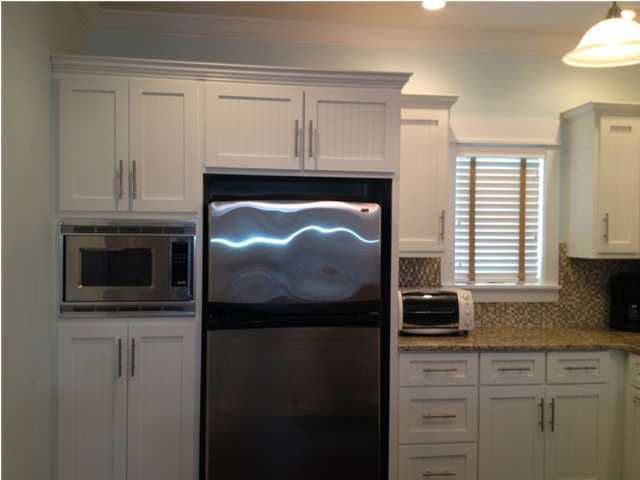 249 Beach Bike Way Seacrest, FL 32461 - Photo 5 of 24 a kitchen with granite countertop white cabinets and refrigerator