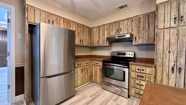 a kitchen with stainless steel appliances a refrigerator stove and a sink