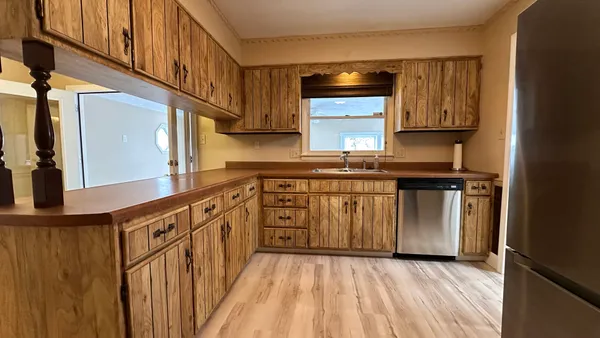 a kitchen with stainless steel appliances a sink and cabinets