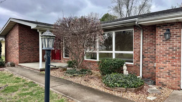 a front view of a house with garden