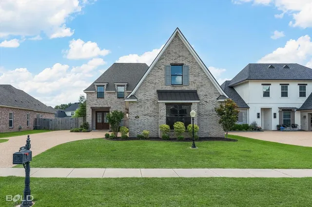 a front view of a house with a yard and outdoor seating