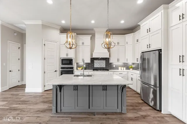 a large kitchen with a large refrigerator a sink and cabinets