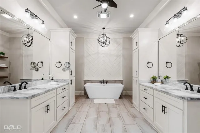 a bathroom with a double vanity sink a toilet a mirror and shower