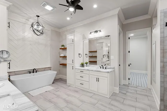 a spacious bathroom with a double vanity sink a mirror and a bathtub