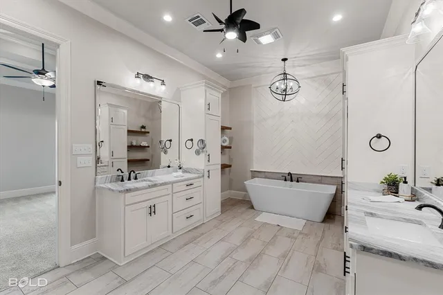 a spacious bathroom with a double vanity sink a mirror and a shower