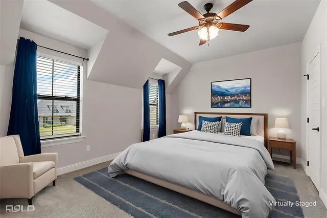 a bedroom with a large bed and a window