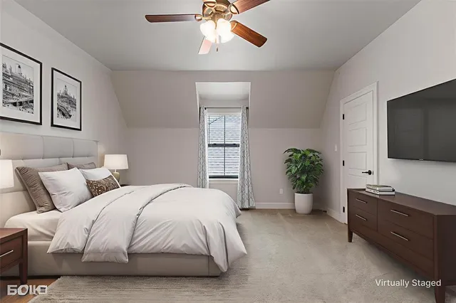 a spacious bedroom with a bed and a flat screen tv