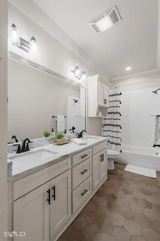 a spacious bathroom with a granite countertop sink a toilet a mirror and bathtub