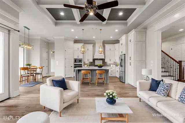 a living room with furniture and kitchen view