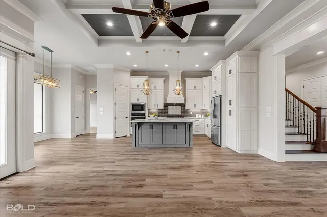 a kitchen with stainless steel appliances granite countertop a refrigerator and a stove