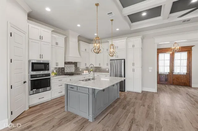 a kitchen with a sink a counter top space stainless steel appliances and a window