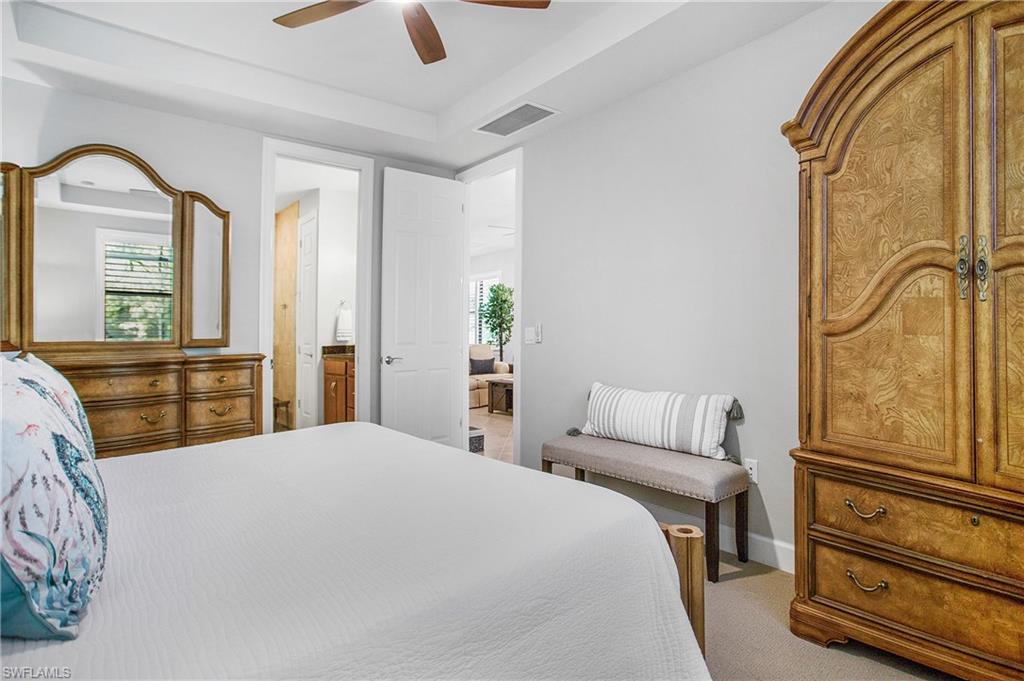 7674 Jacaranda Lane Naples, FL 34114 - Photo 9 of 45 a bedroom with a bed and wooden floor