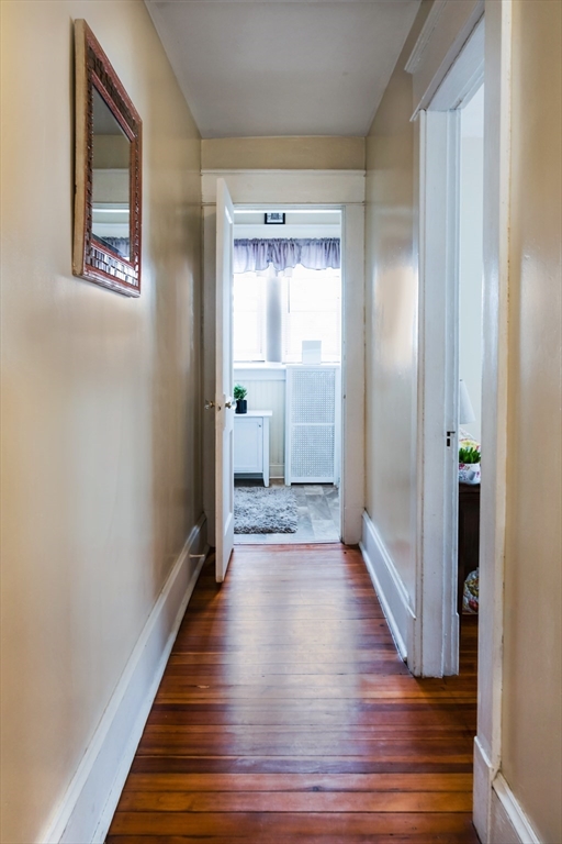 39 Meredith Street Springfield, MA 01108 - Photo 13 of 36 a view of a hallway with wooden floor and a bathroom