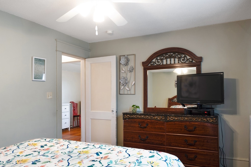 39 Meredith Street Springfield, MA 01108 - Photo 15 of 36 a bedroom with a bed and a flat screen tv